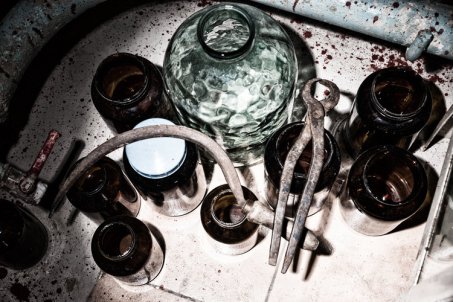 Top view of jars, sickle and tongs in stained laboratory